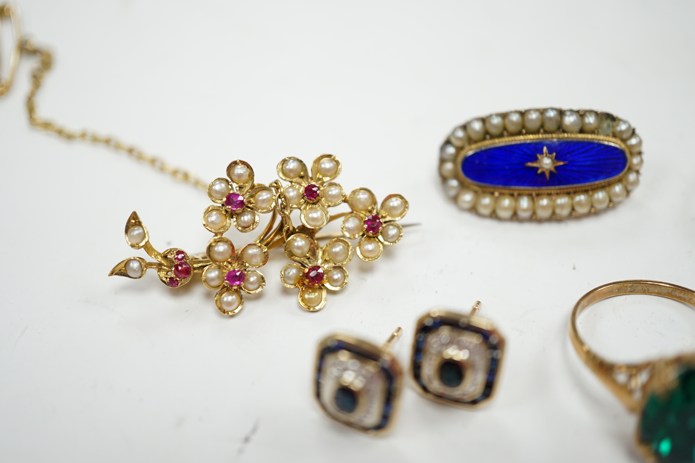 A 750 yellow metal, single stone sapphire and three stone diamond set crossover ring, size, three other yellow metal and gem set rings including a continental 875 white metal and 585 yellow metal, synthetic sapphire or s